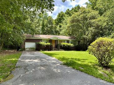 Brick ranch home with driveway and large yard at 8943 Furr St, North Charleston, SC 29406