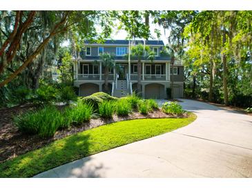 Two story home with a landscaped lawn and driveway at 3350 Seabrook Island Rd, Seabrook Island, SC 29455