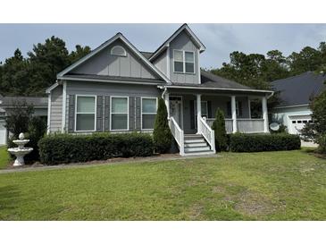 Charming two-story house with gray siding and a white porch at 86 Watershed Ct, Walterboro, SC 29488