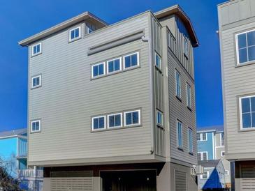 Three-story home with gray siding and garage at 315 Ashley Ave # C, Charleston, SC 29403