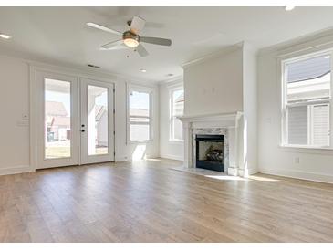 Bright living room with fireplace and hardwood floors at 2193 Blue Bayou Blvd, Johns Island, SC 29455