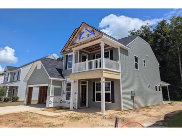 New construction home with gray siding, a balcony, and a two-car garage at 120 Palfrey Dr, Ridgeville, SC 29472