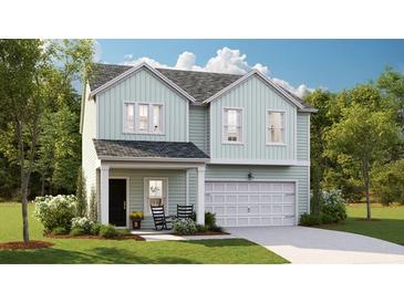 Two-story light green house with a white garage door and rocking chairs on the porch at 1020 Lovebug Ln, Summerville, SC 29485