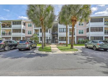 Apartment building exterior with parking and palm trees at 1025 Riverland Woods Pl # 610, Charleston, SC 29412