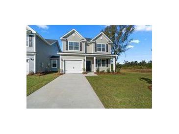 Two-story house with gray siding and a white garage door at 426 Grove End Rd, Moncks Corner, SC 29461