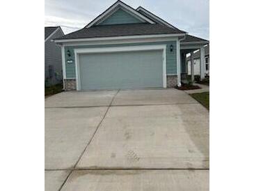 Two-car garage and light gray exterior with stone accents at 741 Blue Iris Way, Summerville, SC 29486