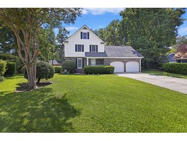 Two-story home with double garage and manicured lawn at 5 Avon Ct, Charleston, SC 29407