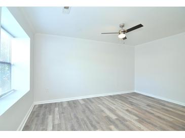 Bright bedroom with neutral walls, wood-look flooring, and ceiling fan at 1910 Tropicana Rd # 9-B, North Charleston, SC 29406
