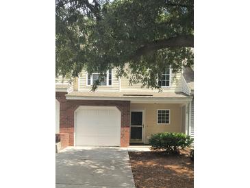 Brick front of townhome with attached garage at 258 Kelsey Blvd, Wando, SC 29492
