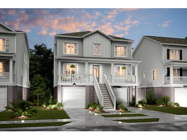 Two-story home with a charming front porch and attached garage at 1668 Siloh Dr # 470, Mount Pleasant, SC 29466
