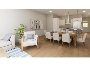 Bright dining area with large wooden table and seating for eight at 7421 Indigo Palms Way, Johns Island, SC 29455