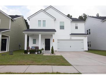 Charming two-story white house with a gray roof and attached garage at 217 Pink Azalea St, Summerville, SC 29485