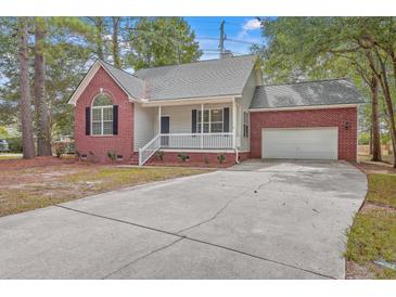 Brick house with attached garage and driveway at 195 Fox Squirrel Run, Summerville, SC 29483