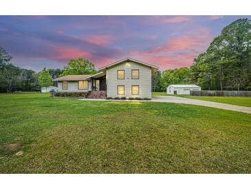 Two-story house with attached garage and landscaping at 225 Cantering Hills Ln, Summerville, SC 29483