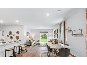 Modern kitchen with white cabinets, granite countertops, and stainless steel appliances at 5528 Bowmore Blvd, Ravenel, SC 29470