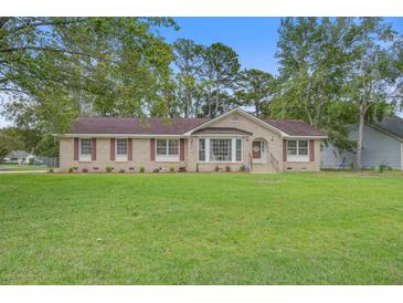 Charming ranch-style home with brick facade, manicured lawn, and mature trees at 213 Blue Heron Dr, Summerville, SC 29485