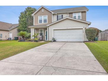 Two-story house with a two-car garage and landscaped lawn at 7160 Sweetgrass Blvd, Hanahan, SC 29410