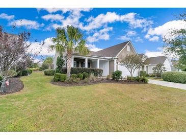 Landscaped front yard with palm trees and curb appeal at 462 Eastern Isle Ave, Summerville, SC 29486