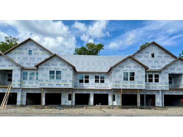 Three-unit building under construction, featuring contemporary design and attached garages at 420 Carolina Cherry Ct # 202, Charleston, SC 29414