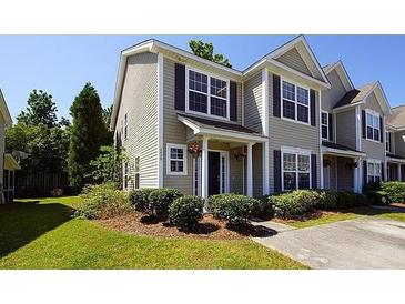 Tan two-story home with dark shutters and landscaping at 2429 Scholar Ln, North Charleston, SC 29406