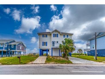 Two-story beach home with blue accents and elevated foundation at 144 Palmetto Blvd, Edisto Island, SC 29438