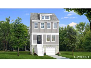 Three-story home with gray siding, white trim, and a two-car garage at 1094 Glenshaw St, North Charleston, SC 29405