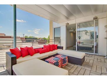 Spacious rooftop patio with sectional seating and city views at 487 King St # 202 Penthouse, Charleston, SC 29403