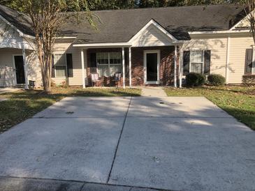 Ranch style home with covered porch, brick accents, and a spacious driveway at 122 Stewart Pl, Summerville, SC 29485