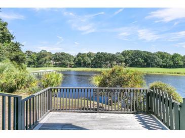 Deck overlooking a tranquil lake and golf course at 4910 Green Dolphin Way, Kiawah Island, SC 29455
