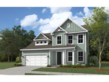 Two-story house with a green exterior and a white garage door at 4 Wappoo Trace Ln, Summerville, SC 29486