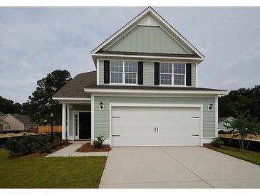 Two-story house with light green siding and white garage door at 173 Cantona Dr, Summerville, SC 29483