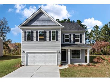 Two-story gray house with white garage door and black shutters at 2802 Lacy St, North Charleston, SC 29406