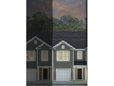 Three-unit townhouse exterior with gray siding and two-car garage at 121 Yarrow Way, Moncks Corner, SC 29461