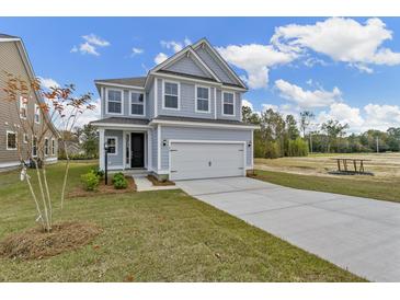 Two-story Craftsman home with gray siding, white trim, and a two-car garage at 424 Grove End Rd, Moncks Corner, SC 29461