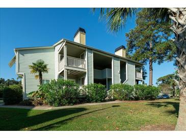 Two-story building with light green siding, balconies, and landscaping at 1481 Center Extension St # 208, Mount Pleasant, SC 29464