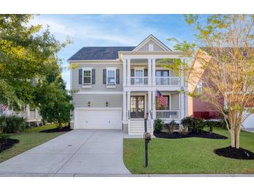 Attractive two-story house with a front porch and American flag at 1174 Ayers Plantation Way, Mount Pleasant, SC 29466