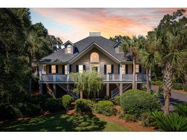 Stunning two-story home with large covered porch and beautiful landscaping at 3906 Heron Marsh Cir, Johns Island, SC 29455