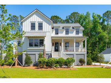 Stunning two-story farmhouse with gray accents and a spacious yard at 1480 Jeremy Cay Ct, Awendaw, SC 29429