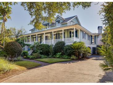 Two-story home with large porch and lush landscaping at 1311 S Jenkins Lagoon Dr, Seabrook Island, SC 29455
