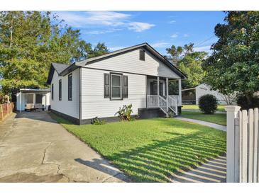 Charming one-story home with a white exterior, porch and carport at 2935 Alabama Dr, North Charleston, SC 29405