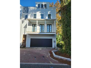 Three-story house with a two-car garage and front porch at 22 Iron Forge Aly, Charleston, SC 29403