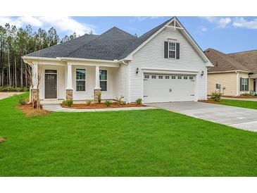 One-story home with a two-car garage and landscaped lawn at 140 Seaton Street, Summerville, SC 29486