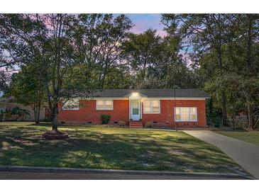 Brick ranch home with a well-manicured lawn at 325 Oxford Rd, Ladson, SC 29456