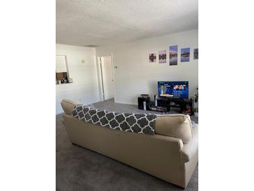 Living room with beige sofa and flat-screen TV at 2150 Spoleto Ln # B-6, North Charleston, SC 29406
