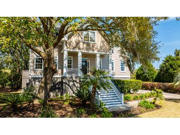 Two-story house with a front porch and lush landscaping at 4233 Haulover Dr, Johns Island, SC 29455