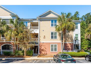 Three story beige apartment building with palm trees and parking at 600 Bucksley Ln # 108, Charleston, SC 29492