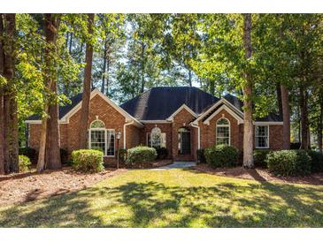 Brick house with a large front yard and mature trees at 4294 Club Course Dr, North Charleston, SC 29420