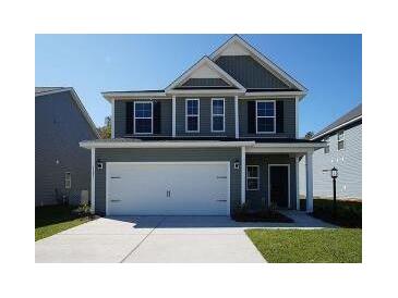 Two-story house with gray siding, white trim, and a two-car garage at 175 Cantona Dr, Summerville, SC 29483