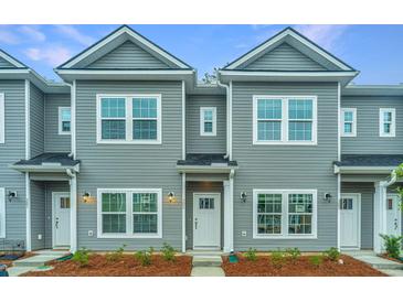 Two-story townhouses with gray siding and white trim at 1103 Twin Rivers Drive # 71, Wando, SC 29492
