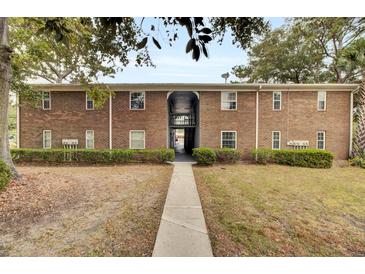 Brick apartment building with walkway and landscaping at 21 Rivers Point Row # 4B, Charleston, SC 29412